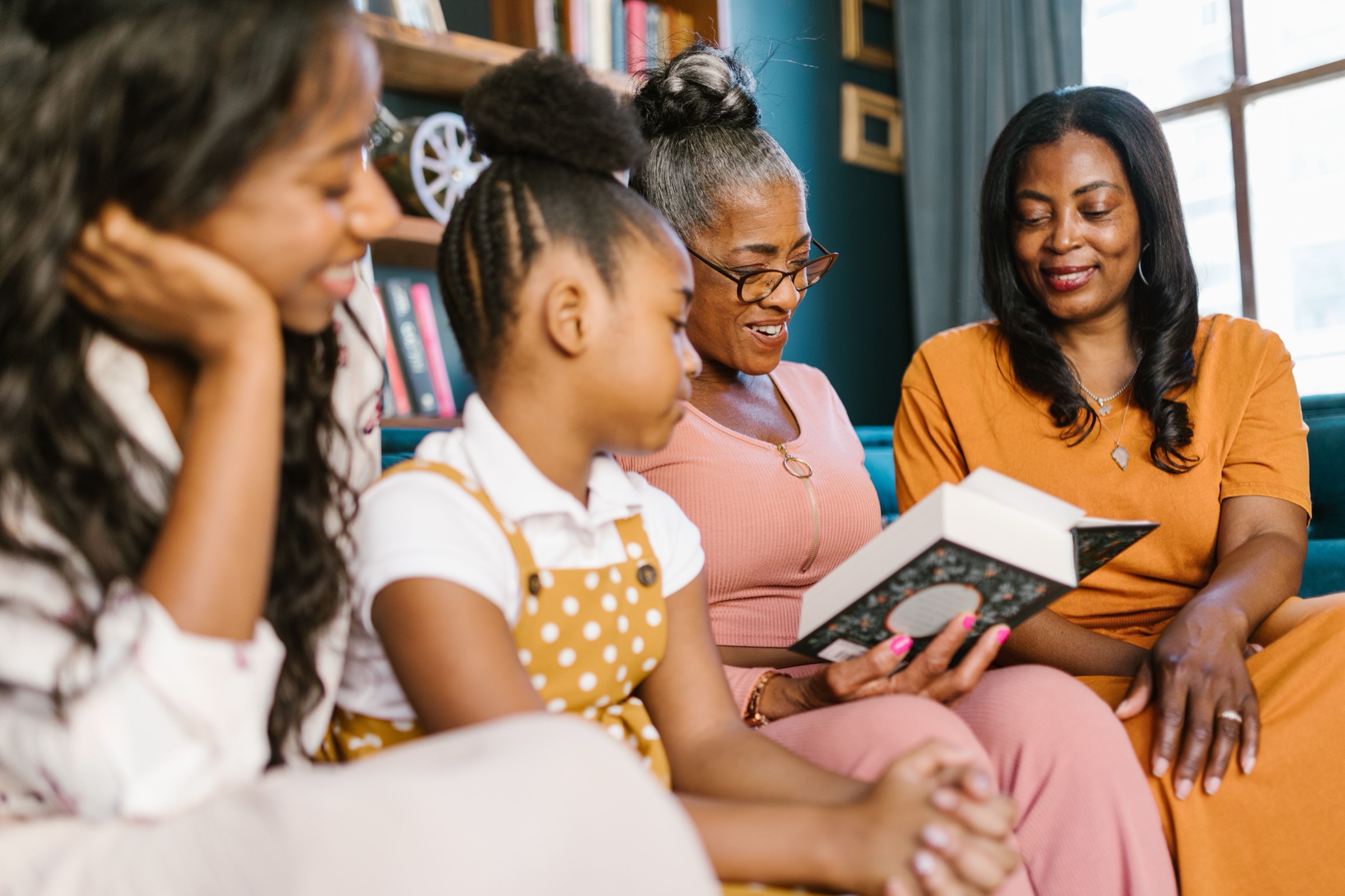 A Black multigenerational family reading together
